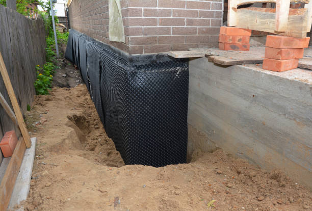 Happy homeowners after waterproofing job in Lyons